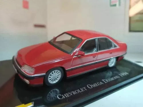 Red 1:43 scale diecast sedan model car with black window trim on display base