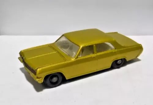 Yellow gold 1:64 diecast model car, side view with open wheels