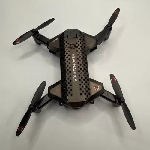 Black quadcopter drone with four propellers, camera-facing front body