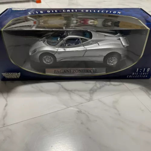 Silver 1:18 scale die-cast sports car model in display box