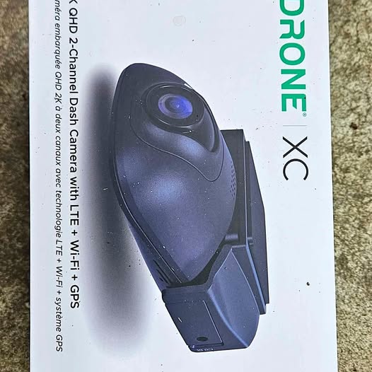 Drone dash cam with circular lens and mount, dark blue-gray body