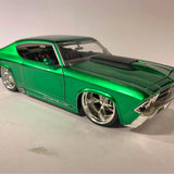 Green 1/24 scale diecast sports car model with chrome wheels and hood scoop.