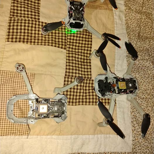 DJI Mavic Mini disassembled drone parts with propellers and circuit board
