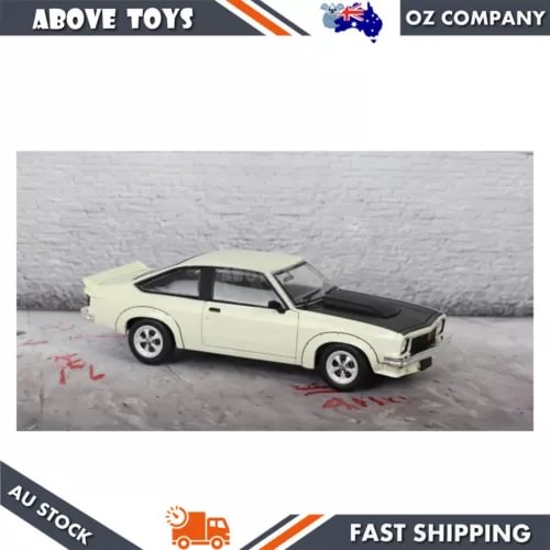 White diecast toy car with black hood, Holden A9X Torana scale model, side view
