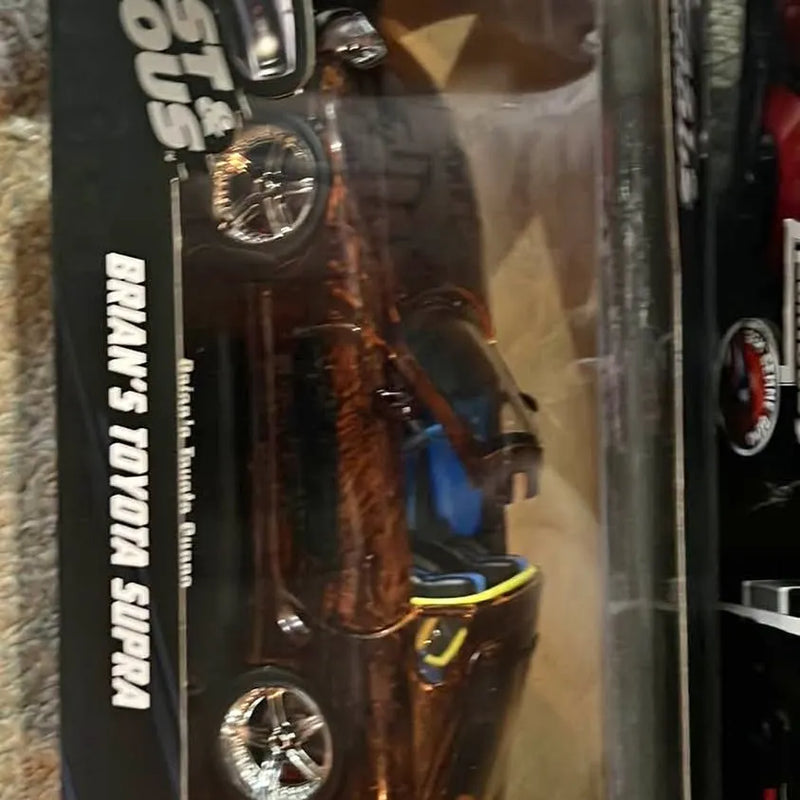 Toyota Supra 1/18 diecast car, black and chrome with window box packaging.