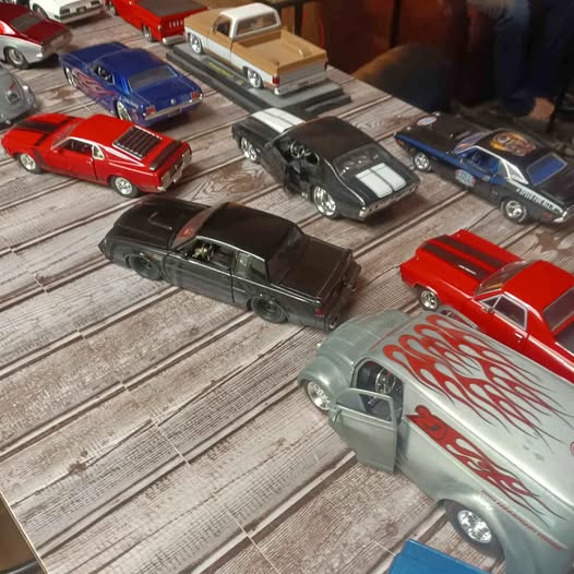 Diecast car collection with multiple classic cars, red, blue, black, and silver models