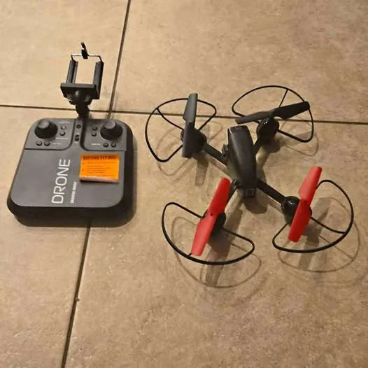 Remote control drone with handheld controller, gray body and red prop guards