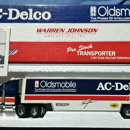 1/64 scale diecast hauler truck with red, white and blue transporter trailer