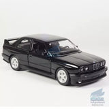 Black BMW M3 1987 diecast model car with white wheels, front 3/4 view