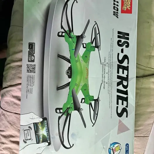 Green quadcopter drone with four arms shown on its retail box packaging