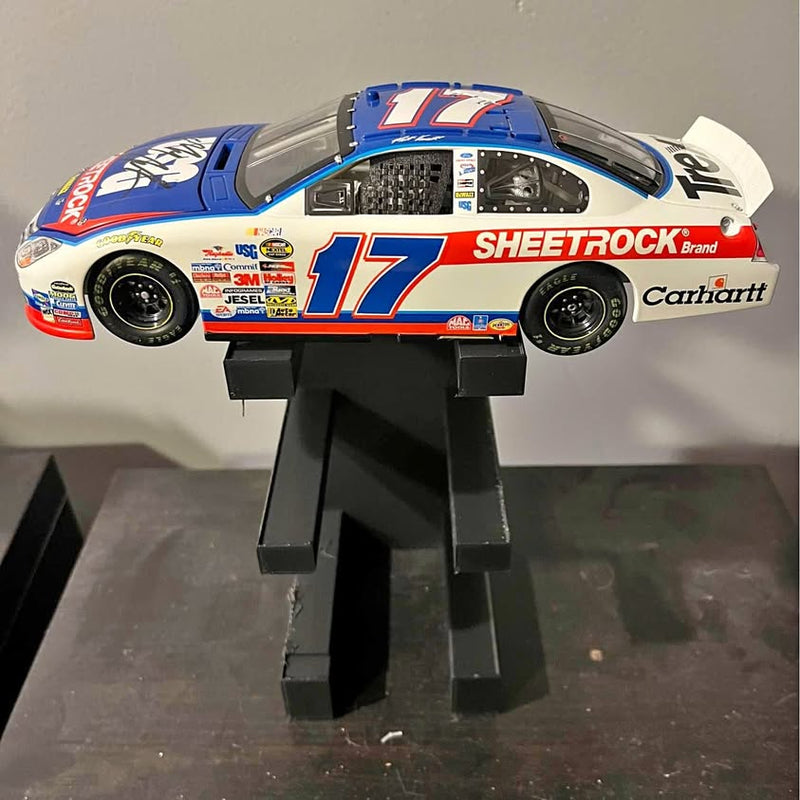 Diecast race car replica with black display stand, blue #17 Sheetrock and Carhartt graphics