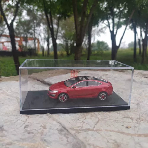 Red concept car diecast model in clear display case