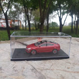 Red concept car diecast model in clear display case