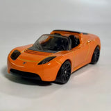 Orange Tesla Roadster 1:64 diecast model car, front three-quarter view, black wheels
