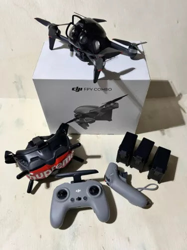 FPV drone quadcopter kit with controller, goggles, and batteries, black and gray