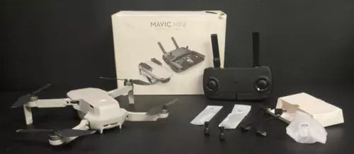 DJI Mavic Mini drone with remote control and spare propeller blades
