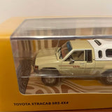 Diecast Toyota Xtracab SR5 4x4 pickup truck model in clear display box, tan