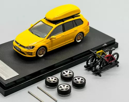 Yellow alloy diecast wagon car model with spare wheels and tools on display base