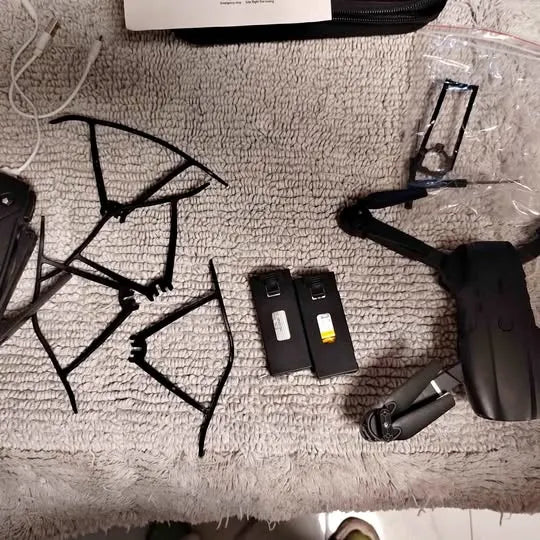 Foldable drone with remote controller and spare battery packs