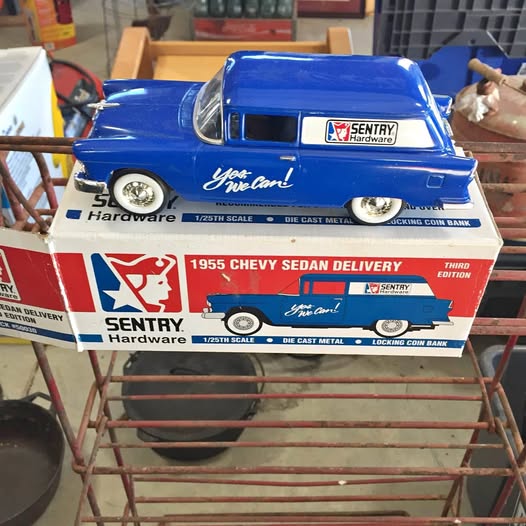 Blue 1955 Chevy sedan delivery diecast car, front view on display box