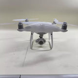 Grey quadcopter camera drone with front gimbal-mounted camera and four propellers