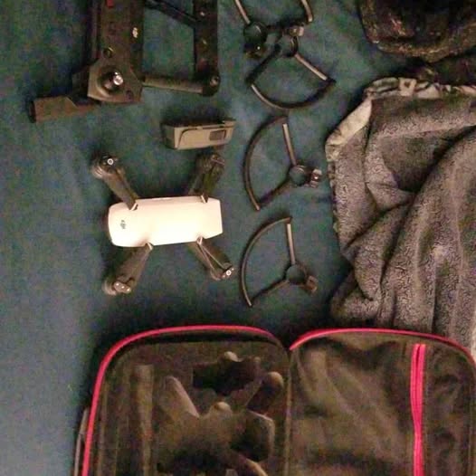 Drone with propellers and spare parts in padded carrying bag