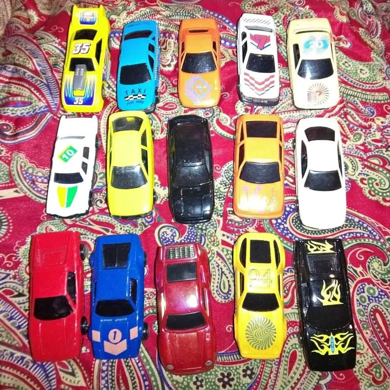 Assorted diecast toy car lot with multiple vehicles in red, blue, yellow, white.