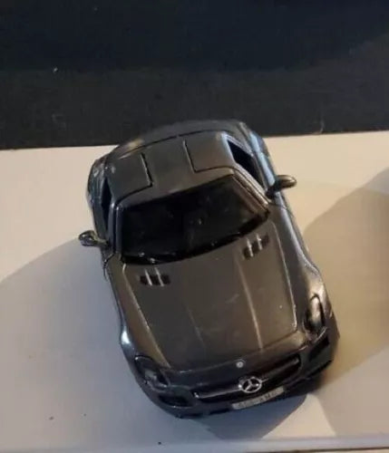 Gray diecast toy Mercedes-Benz SLS AMG car, angled top-front view