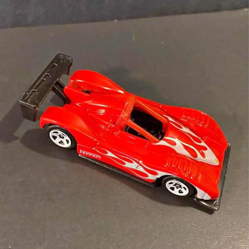 Red die-cast race car with white flame decals, black cockpit, and side exhaust