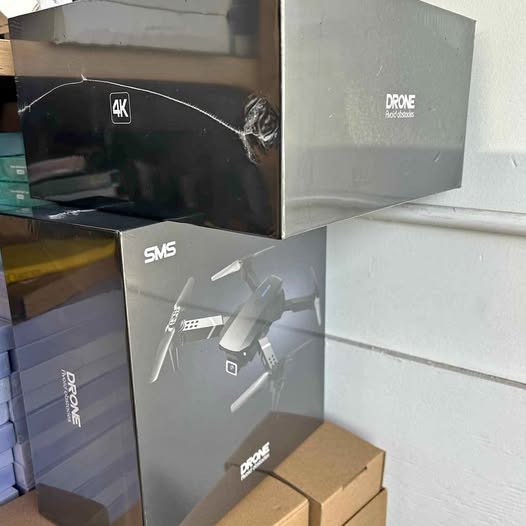 Boxed 4K drone with SMS branding and propeller graphic