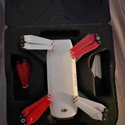 DJI drone with red propellers, boxed in protective packaging