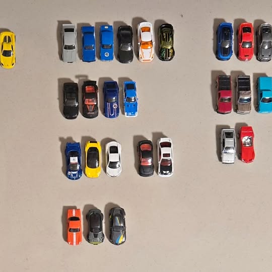 Loose diecast toy cars assortment, various colors and styles in a grid layout