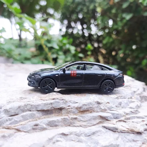 Diecast electric car model in dark gray, side view, black wheels