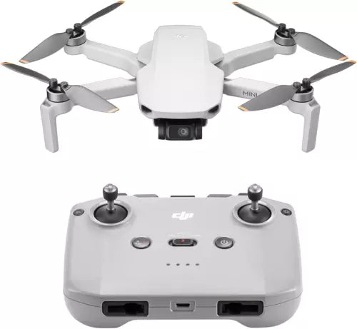 Foldable white quadcopter drone with camera and handheld remote controller
