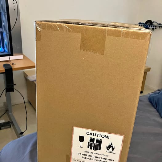 Cardboard shipping box for a drone with caution and battery warning label