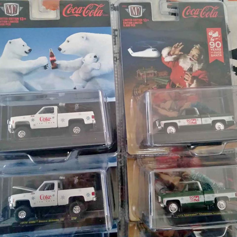 Coca-Cola M2 diecast pickup truck model in clear blister packaging, white cab with red logo.