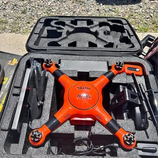 Orange and black Autel robotics drone with arms and propellers in hard case