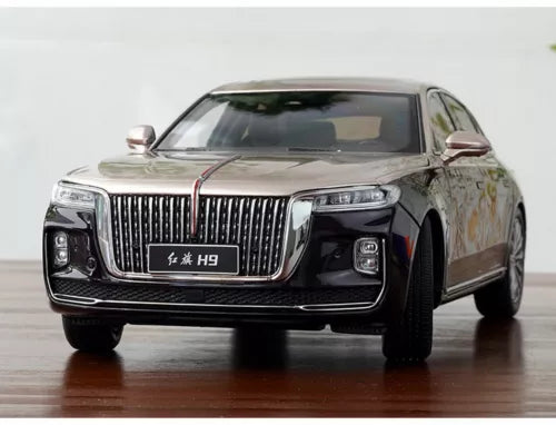 Diecast car model, front view, dark body with chrome grille and gold accents