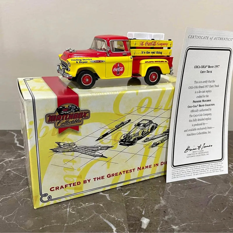 Diecast toy Chevrolet truck in box with Coca-Cola graphics and COA certificate card
