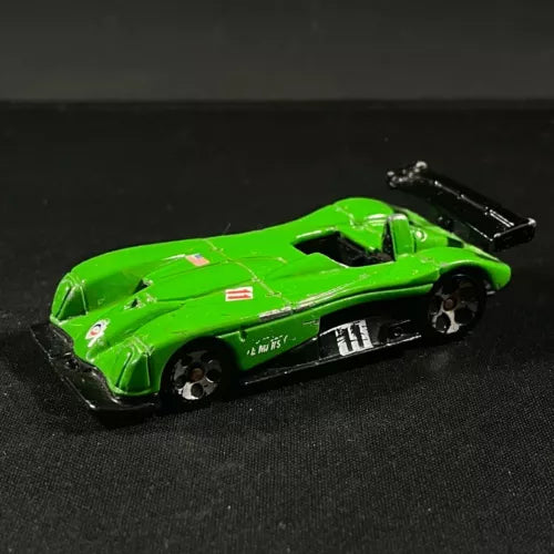 Green diecast race car roadster with black hood and rear wing