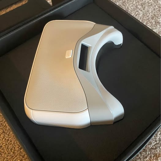 DJI drone goggles, white headset with curved faceplate and beige control panel