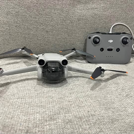 DJI Mini 3 Pro drone with remote controller, gray body and gimbal camera