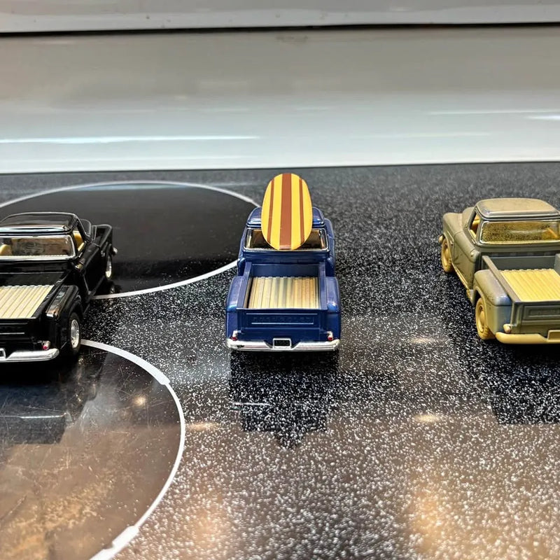 Diecast toy truck set of three, blue cab with yellow stripes and two vehicles