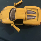Kinsmart Porsche Carrera GT yellow diecast model toy car, front-side view