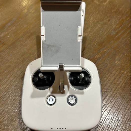 DJI drone remote controller with dual thumb controls and phone holder, white