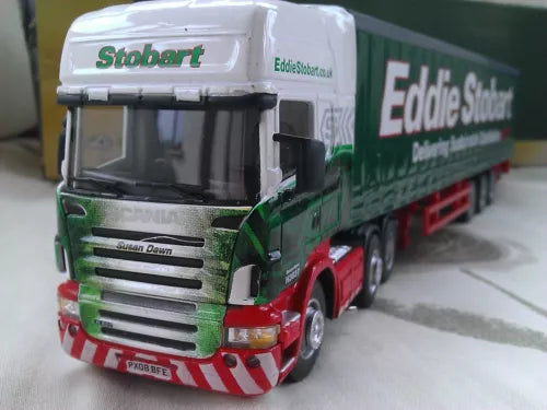 Green and white diecast curtainside truck with red wheel arches and front grille detail