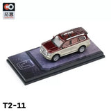 1/64 scale diecast SUV model in maroon and beige, front three-quarter view