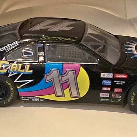 Black diecast race car with bright '11' hood graphic
