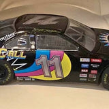 Black diecast race car with bright '11' hood graphic