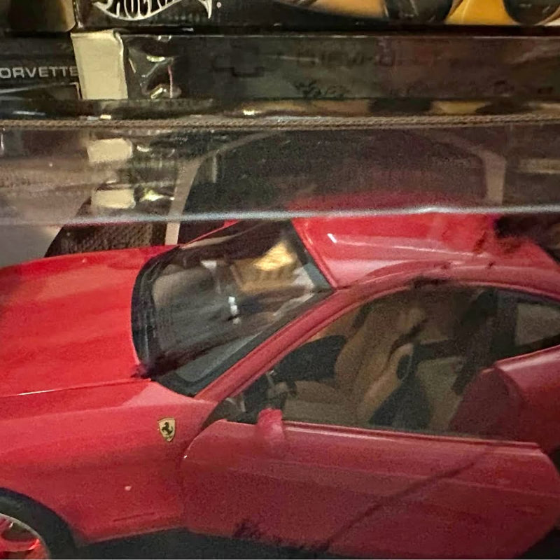 Red diecast Ferrari 612 model car by Hot Wheels, front side view